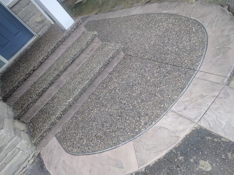 Exposed aggregate entrance steps with curved stamped border