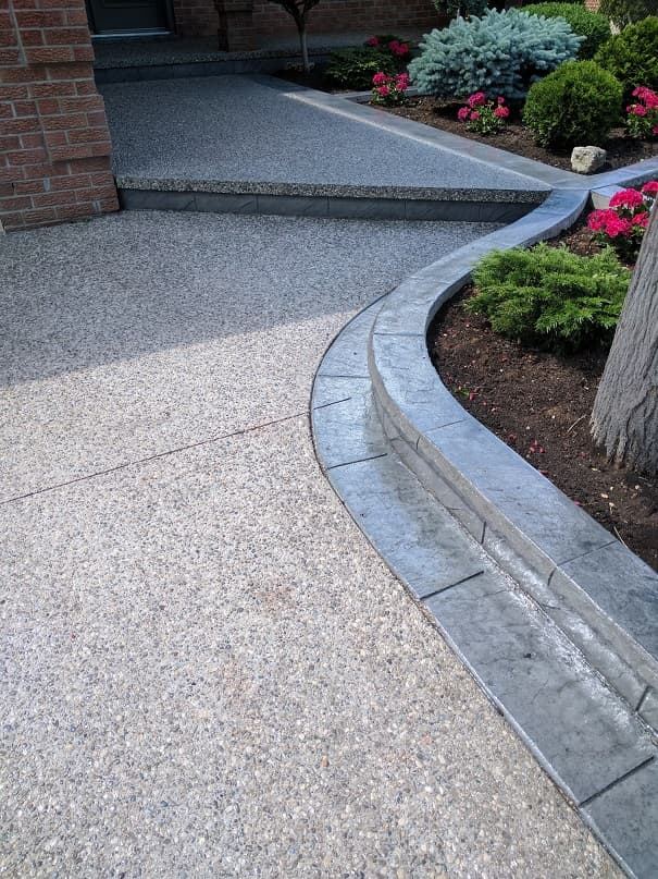 Exposed aggregate walkway with curved stamped curb