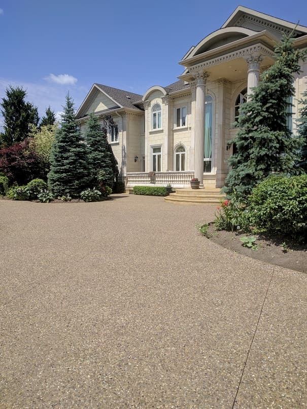 Exposed aggregate driveway in front of a house