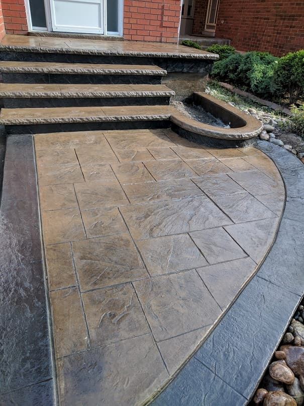 Stamped concrete entrance steps with stone pattern