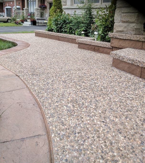 Exposed aggregate walkway with stamped border and planters