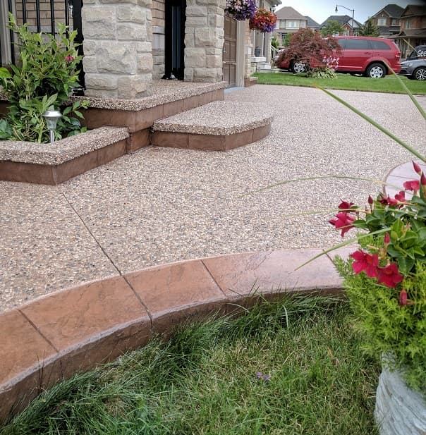Stamped concrete curb with exposed aggregate walkway