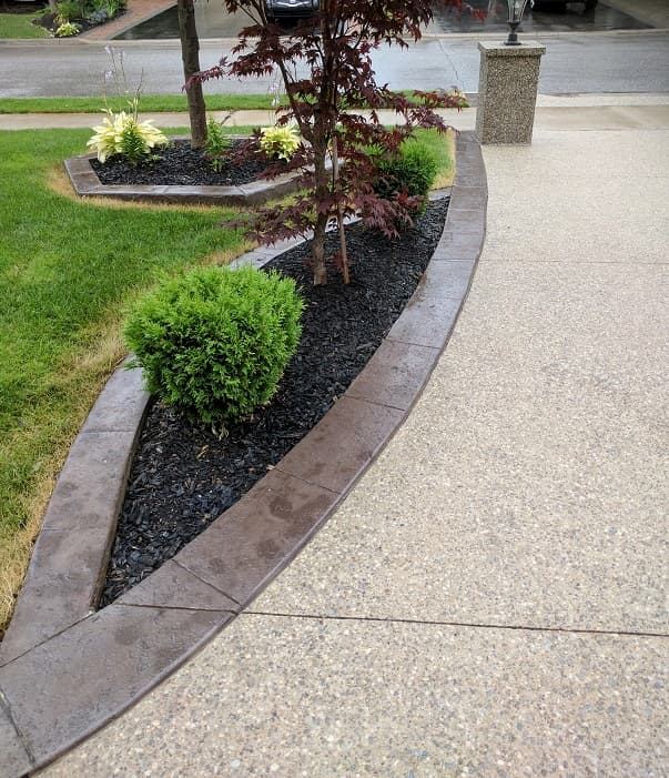 Exposed aggregate driveway with stamped landscape border