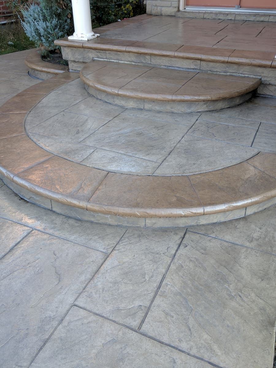 Stamped concrete patio with circular medallion and steps