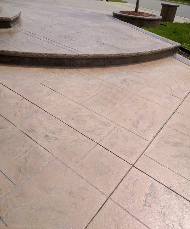 Stamped concrete patio in warm tones with curved edge