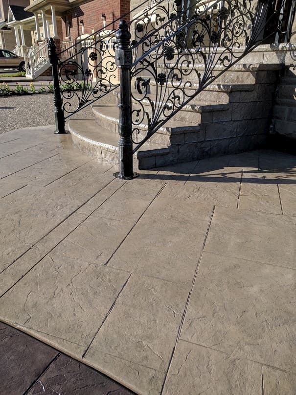Stamped concrete steps with wrought iron railing