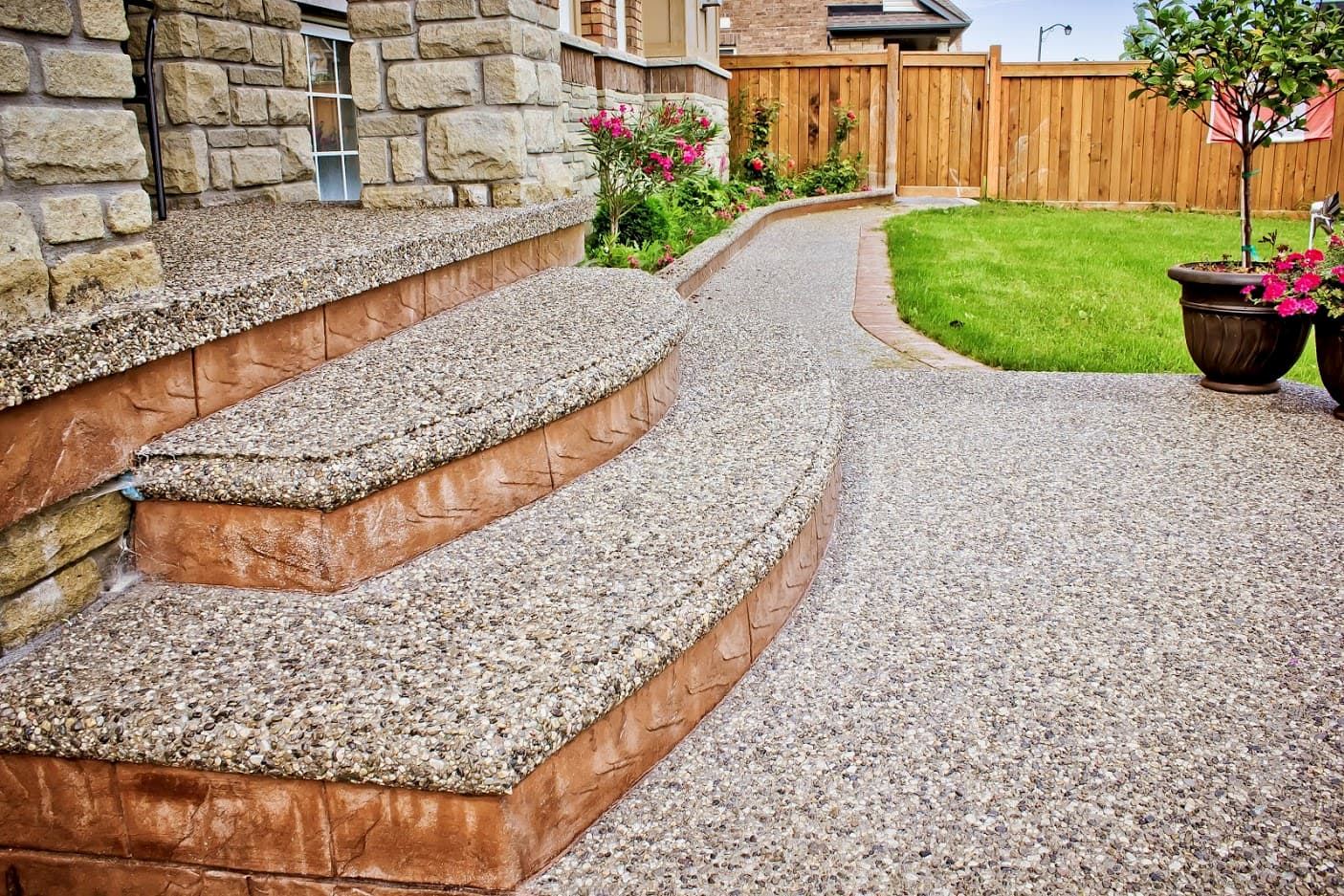 Exposed aggregate steps with brick-pattern stamped risers