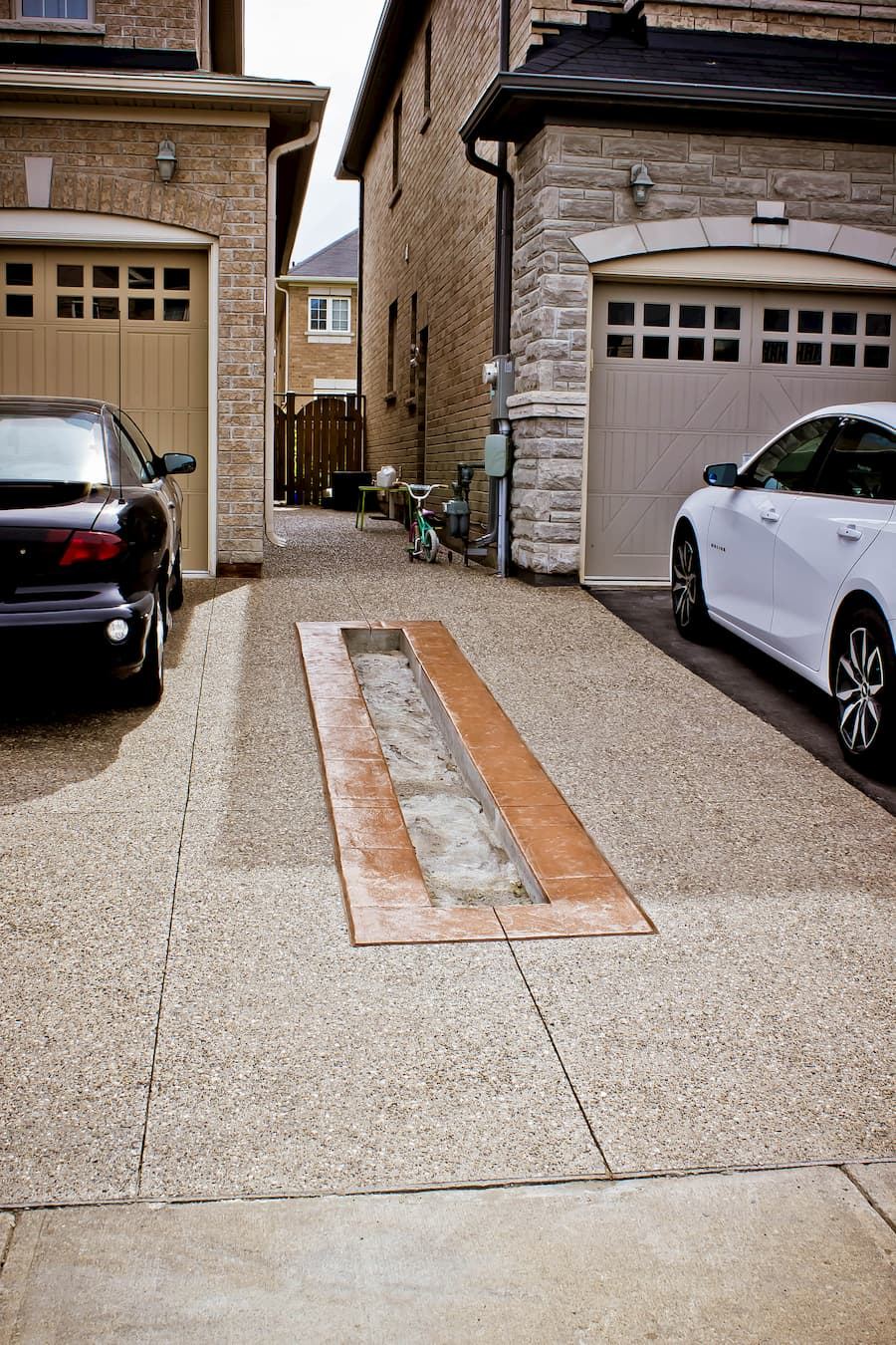 Exposed aggregate driveway with decorative inlay strip