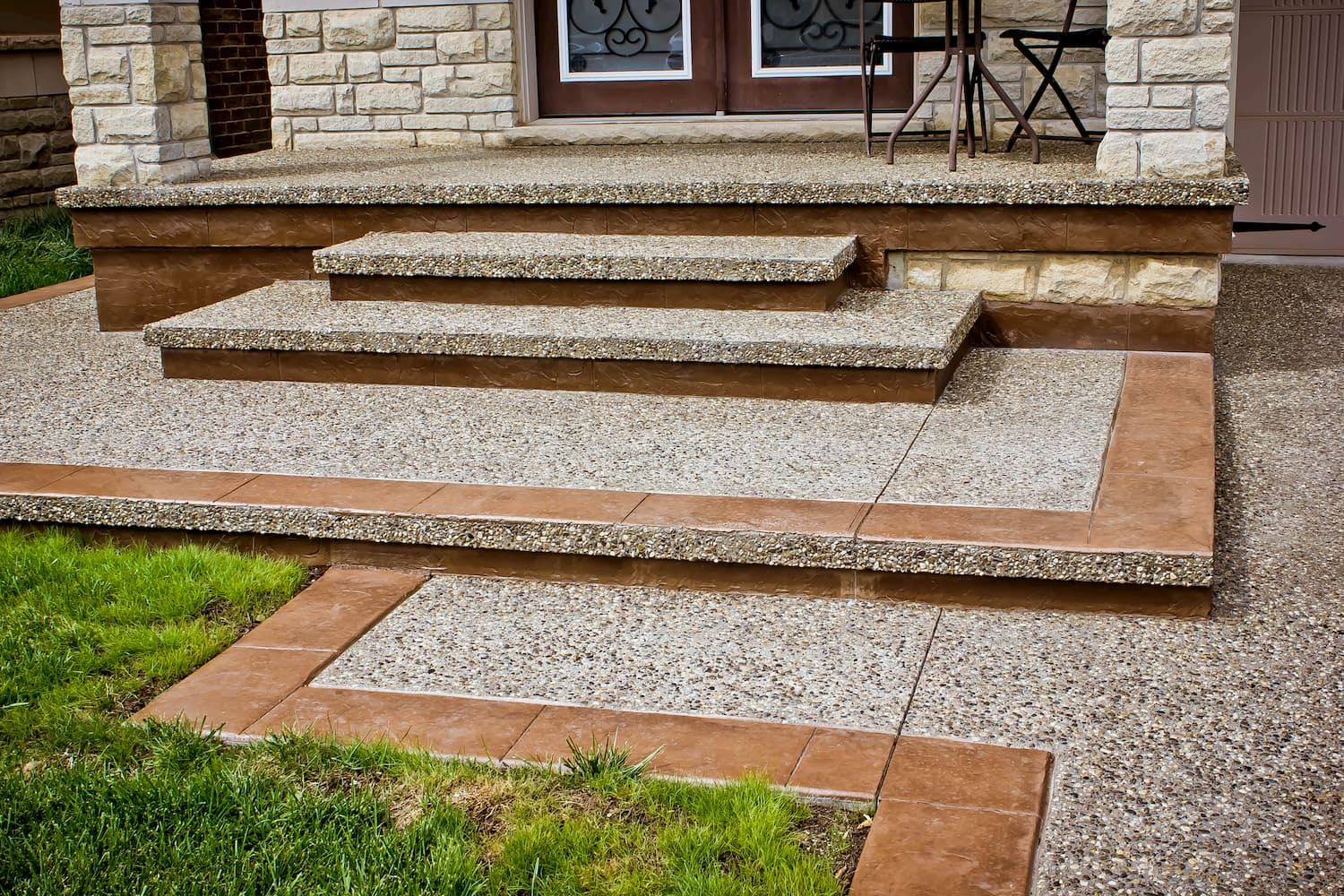 Exposed aggregate steps with stamped landing and brick border